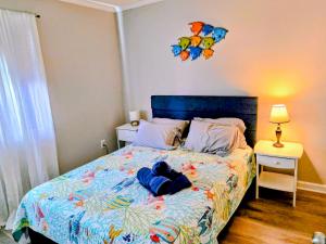 a bedroom with a bed with a blue comforter at Beachfront Condo 103 in North Topsail Beach