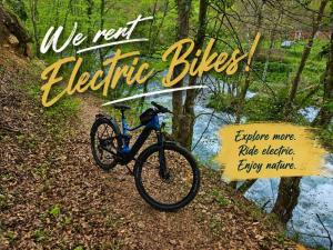a bike parked on a trail next to a river at Bungalov La Repit in Šipovo
