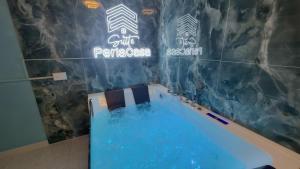 a bathroom with a blue tub in a room at Suite Perlacasa in Vigevano
