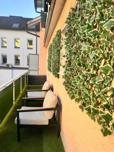 a vertical garden on the side of a building with plants at E&H Appartements in Bregenz