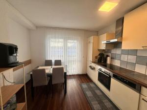 a kitchen with a table and chairs in a room at E&H Appartements in Bregenz