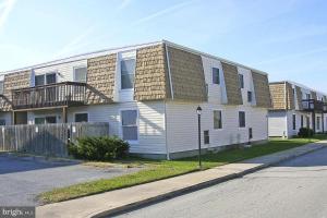 a white house with a balcony on the side of a street at Beach Condo in Ocean City, MD in Ocean City