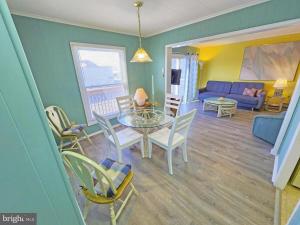 a living room with a table and chairs and a couch at Beach Condo in Ocean City, MD in Ocean City