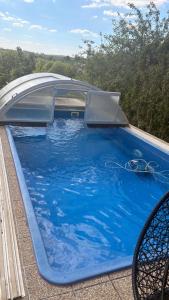 a large blue swimming pool on top of a roof at Holiday Home V Kolte in Kolta