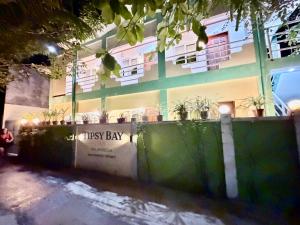 a building with a risk bay sign in front of it at Tipsy Bay Inn - Malapascua in Daanbantayan