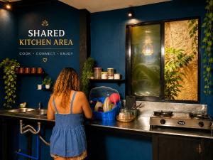 a woman standing at a counter in a kitchen at Wave Cafe INN in General Luna +20 photos
