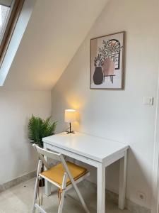 a white desk with a lamp and a chair at L'écrin de marbre, hyper centre, PARKING in Quimper