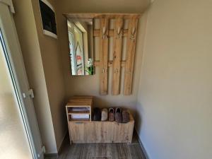 a room with a mirror and a shelf with shoes at Apartmani Alibi in Kula