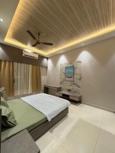 a bedroom with a bed and a ceiling at Jhigu in Siliguri