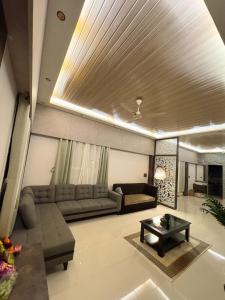 a living room with a couch and a table at Jhigu in Siliguri