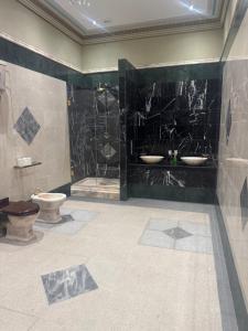 a bathroom with two sinks and a shower at Plas Glynllifon Mansion in Caernarfon +11 photos