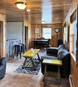 a living room with a couch and a table at Augustus Jane Inn in Rocky Harbour