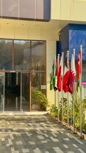 a row of flags in front of a building at سمسمه للشقق المخدومه in Quai +7 photos