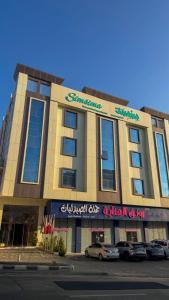 a building with cars parked in front of it at سمسمه للشقق المخدومه in Quai