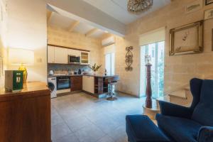 a living room with a couch and a kitchen at 3BR Townhouse with Private Rooftop in Bormla in Taʼ Penza