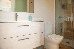 a bathroom with a toilet and a sink and a shower at Casa Ines in Playa Honda
