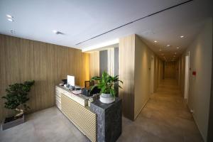 a hallway of an office with a desk with a plant at Hotel Panorama Ksamil in Ksamil