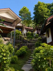 a path leading to a house with trees and bushes at Flow Jungle Residency in Haad Yao