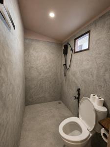 a bathroom with a toilet and a window at Flow Jungle Residency in Haad Yao +110 photos