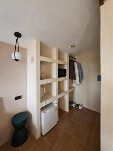 a room with white shelves and a blue stool at Flow Jungle Residency in Haad Yao