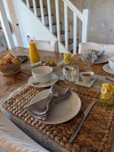 a table with plates of food on top of it at Les Chambres De La Loge in Montmorillon