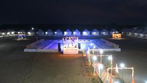 a group of huts with lights at night at Big Brand Desert Camp in Jaisalmer