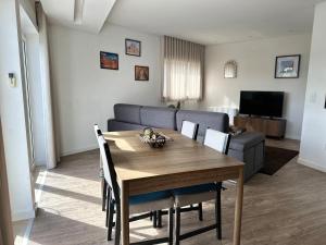 a living room with a table and a couch at Casa das Flores in Batalha