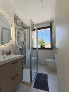 a bathroom with a shower and a sink and a tub at Sole Relax Pula in Pula +20 photos