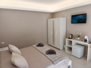 a bedroom with a bed with two towels on it at Sole Relax Pula in Pula