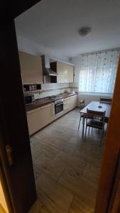 a kitchen with a table and a dining room at Casă in Năvodari
