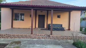 a house with a covered porch with a couch at Casă in Năvodari