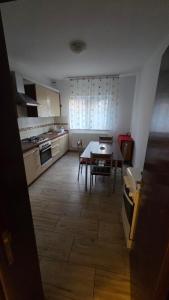 a kitchen with a table and chairs in a room at Casă in Năvodari +6 photos