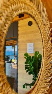a mirror reflection of a building with a sign in it at Sunset Coast - Paradise Cottage in Drage +32 photos