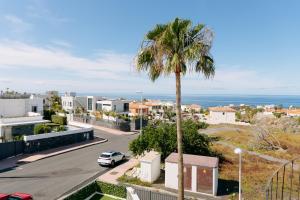 a palm tree and a street in a city at Modern 2BR Villa Private Heated Pool, BBQ, Aircon in Costa Adeje by Aqua Vista Tenerife in Callao Salvaje