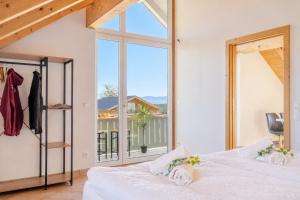 a bedroom with a large window and a bed at Bright Lake View Apartment with Balcony and Air Conditioning in Tutzing