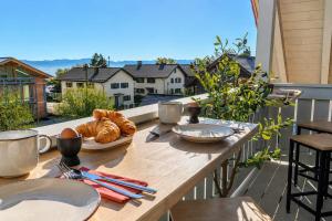 a table with bread and croissants on a balcony at Bright Lake View Apartment with Balcony and Air Conditioning in Tutzing