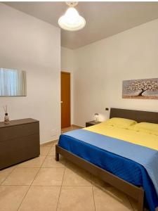 a bedroom with a large bed with a blue blanket at Blue House in Martinsicuro