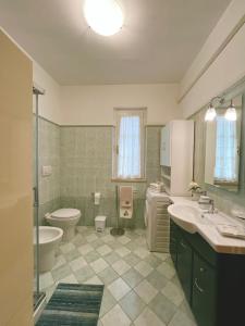 a bathroom with a toilet and a sink and a shower at Blue House in Martinsicuro