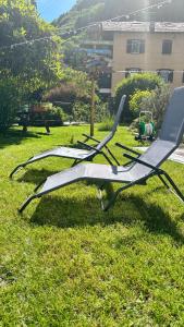 a group of lawn chairs sitting in the grass at La Casa di Adele in Tirano