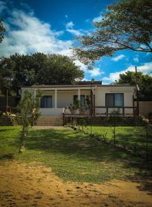a house with a fence in front of it at OasisBhmz in Ponta do Ouro