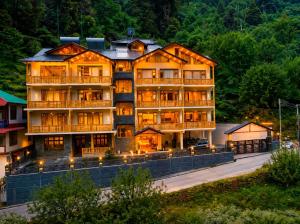 a large building with lights in front of it at Regal Retreat Inn in Shirir