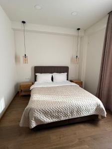 a bedroom with a large bed with two night stands at La Montagna in Bangveti