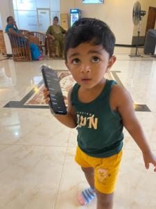 a young boy holding a remote control in a mall at The Dream City Hotel in Kilinochchi +2 photos