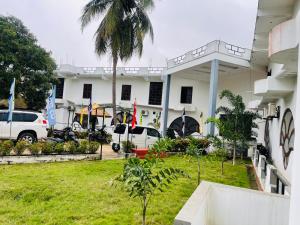 a white building with cars parked in front of it at The Dream City Hotel in Kilinochchi