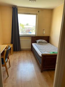 a small bedroom with a bed and a window at Nya Dacke in Virserum