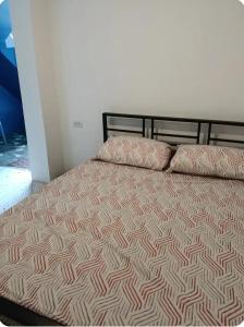 a bed with two pillows on top of it at Bedroom for 2 in Uptown CDO in Balulang