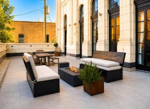 a patio with two benches and a fire pit at The Haven Loft in Birmingham