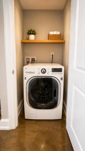 a washer and dryer sitting in a laundry room at The Haven Loft in Birmingham