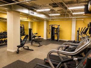 a gym with several treadmills and exercise machines at The Haven Loft in Birmingham