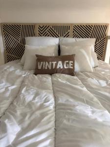 a white bed with a pillow on top of it at L'Instant Parfumé in Grasse